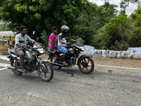 People are driving along the road in Nilakkottai, Tamil Nadu, India. (