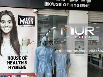 Mannequins are standing outside a shop that is selling face masks, hand sanitizer, and other personal protective equipment to help protect a...