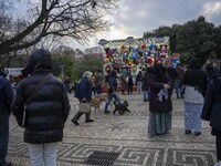 A group of people is walking through the aisles of a Christmas fair near Eduardo VII Park in Lisbon, Portugal, on December 30, 2023. (