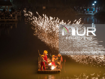 Tourists are enjoying a performance of Striking Iron Flower to welcome the new year in Hefei, Anhui Province, East China, on December 30, 20...