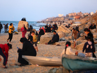 Palestinians are enjoying the last sunset of the year in Deir al-Balah, in the central Gaza Strip, on December 31, 2023, amid the ongoing co...