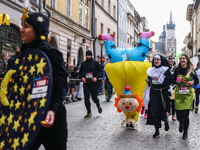 People dressed in funny costumes attend the traditional 19th Krakow New Year's Run in the Old Town in Krakow, Poland on December 31, 2023. T...