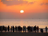 Tourists are watching the New Year sunrise at the Golden Beach in Qingdao, China, on January 1, 2024. (