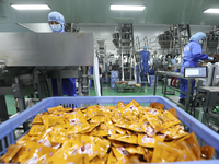 Workers are producing fish products at a workshop of a natural food company in Zixing, China, on January 4, 2024. (