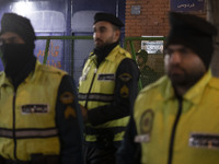 Iranian diplomatic police forces are standing guard in front of the British embassy amidst a gathering of anti-U.S. and anti-British protest...