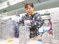 A worker is producing PTC heating block products at a micro factory in Xiashe village, Huzhou, China, on January 15, 2024. (