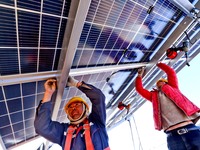 Builders are installing photovoltaic panels at the construction site of a 100,000 kW photovoltaic power generation project in Zhangye, China...