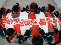 Children from a paper-cutting club are creating works themed on the Year of the Dragon to welcome the Spring Festival in Suqian, Jiangsu Pro...