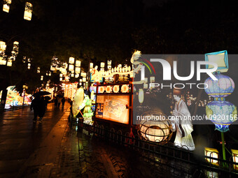Tourists are viewing a lantern show in the rain at Bailu Zhou Park in Nanjing, China, on January 17, 2024. (