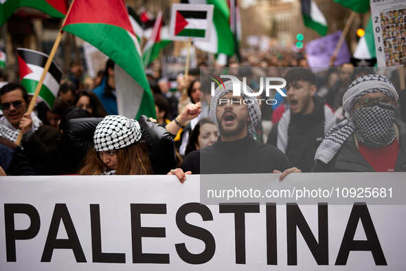 Protesters are holding Palestinian flags and shouting slogans in support of Palestine and against the Israeli government's actions in the Ga...