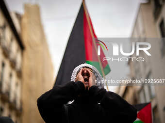 A protester is shouting slogans in support of Palestine and against the Israeli government's actions in the Gaza Strip during a demonstratio...