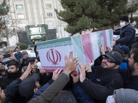 Mourners are carrying the coffin containing the body of the Islamic Revolutionary Guard Corps' (IRGC) Quds Force military personnel, Mohamma...