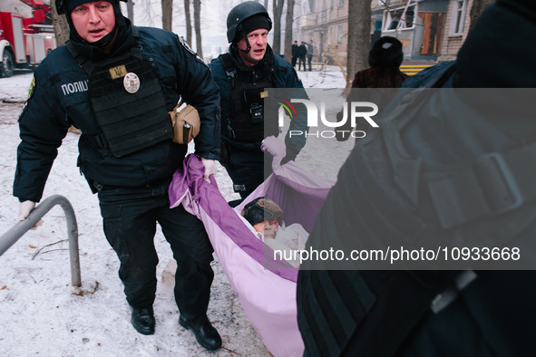 The police are carrying the injured man, in Kharkiv, Ukraine, on January 23, 2024. On The Morning Of January 23, 2024, Russia Launched A Mas...