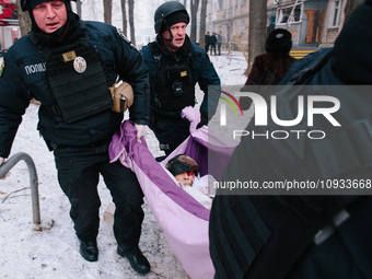 The police are carrying the injured man, in Kharkiv, Ukraine, on January 23, 2024. On The Morning Of January 23, 2024, Russia Launched A Mas...