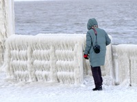 A tourist is viewing the frozen scene at the seaside in Yantai, China, on January 22, 2024. (