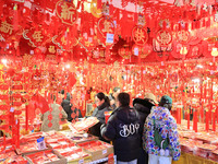 People are shopping for Spring Festival ornaments at a shopping mall in Nanjing, China, on January 27, 2024. (