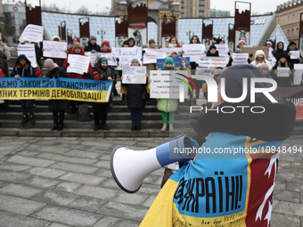 Participants are holding placards during a protest by military relatives who are demanding the demobilization of soldiers after 18 months of...