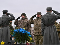 Servicemen are saluting during a ceremony to commemorate the Kruty Heroes on the 106th anniversary of the Battle of Kruty, which took place...