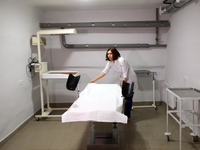 A medical worker is seen in the bomb shelter of the maternity hospital that is being repaired after Russian shelling in March 2022, in Khark...