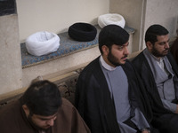 Young Iranian clerics are sitting in front of their turbans while participating in a turban-wearing ceremony at a seminary in Qom, Iran, on...