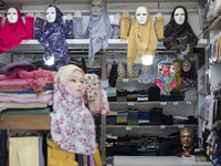 Mannequins are being decorated with headscarves at a shop in the holy city of Qom, 145 km (90 miles) south of Tehran, on February 7, 2024. Q...