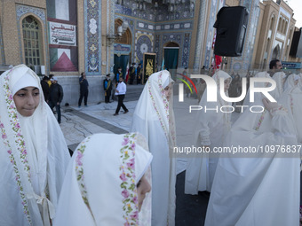 Veiled Iranian schoolgirls are participating in a ceremony at the holy mosque of Jamkaran on the outskirts of the holy city of Qom, 145 km (...
