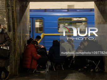 Schoolchildren are completing a school assignment in a metro station being used as a bomb shelter during a long air alert in Kyiv, Ukraine,...