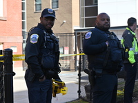 Police officers are standing watch over the crime scene where students are reportedly victims of a robbery at Thurgood Marshall Academy Publ...