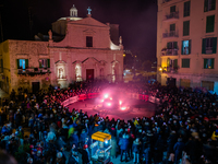 Fireworks are illuminating the bonfire of St. Conrad in Dante Square, Molfetta, Italy, on February 9, 2024, to celebrate the patron saint St...