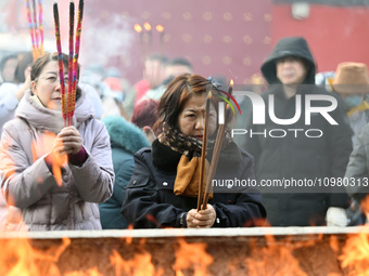 People are burning incense sticks at the temple in Shenyang, Liaoning Province, China, on February 10, 2024. (