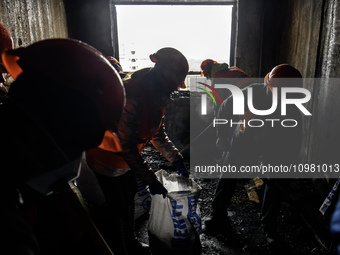 Local residents and volunteers are cleaning up debris in an apartment building that was heavily damaged during a massive Russian missile att...