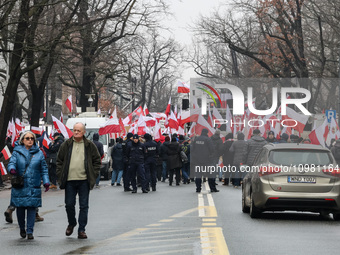 A amall crowd of people, holding Polish national flags and anti-government banners, led by far right media - Gazeta Polska and TV Republica...