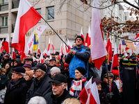 A crowd of people, holding Polish national flags, led by far right media - Gazeta Polska and TV Republica and Law and Justice (Prawo i Spraw...
