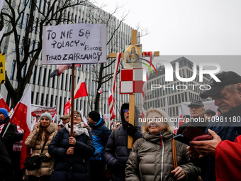 A crowd of people, holding Polish national flags and anti-government banners, led by far right media - Gazeta Polska and TV Republica and La...