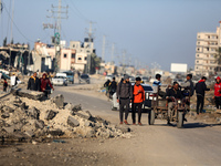 Palestinians are walking along Salah al-Din Road in Deir Al-Balah, in the central Gaza Strip, on February 11, 2024, amid the ongoing conflic...