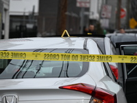 Authorities are investigating a vehicle that has been struck by gunfire at the scene of a shooting in Paterson, New Jersey, on February 11,...