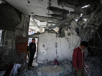 Palestinians are inspecting the damage caused by Israeli bombardment in Deir al-Balah, central Gaza Strip, on February 12, 2024, as battles...