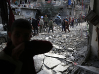 Palestinians are inspecting the damage caused by Israeli bombardment in Deir al-Balah, central Gaza Strip, on February 12, 2024, as battles...