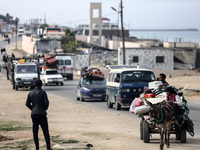 Palestinian families are fleeing Rafah on the southern Gaza Strip, taking the coastal road toward Deir Al-Balah in the central Gaza Strip, o...
