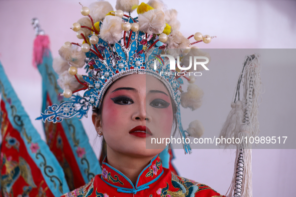 A Chinese artist is posing for photos during a cultural fair at Tundikhel in Kathmandu, Nepal, on February 12, 2024, to celebrate Chinese Ne...