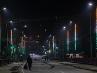 Kashmiri people are shooting videos as the bridge is being illuminated with the Tri-Color (Indian National Flag colors) in Baramulla, Jammu...