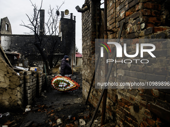 People are bringing toys, candles, and flowers in front of the house in Kharkiv, Ukraine, on February 12, 2024, where a family with their th...