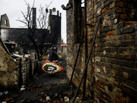 People are bringing toys, candles, and flowers in front of the house in Kharkiv, Ukraine, on February 12, 2024, where a family with their th...