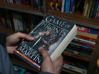 A man is holding a 'Game of Thrones' book at the 'Bestseller' bookshop in Srinagar, Kashmir, India, on February 12, 2024. For the first time...