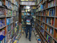 A man is picking books at the 'Bestseller' bookshop in Srinagar, Kashmir, India, on February 12, 2024. For the first time, a bookstore in Ka...