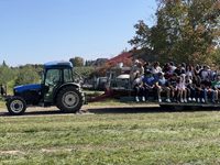 People are taking a wagon ride to an apple orchard for apple picking in Stouffville, Ontario, Canada, on September 24, 2023. (