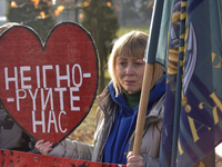 A woman is holding a heart-shaped red placard during a rally in Yevropeiska Square in Vinnytsia, Ukraine, on February 10, 2024, to remind pe...