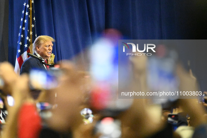 Former U.S. President Donald Trump is speaking on stage during an appearance at SneakerCon at the Pennsylvania Convention Center in Philadel...