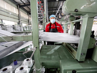 A worker is producing textile products at a workshop of a production enterprise in the Lianyun district, Lianyungang City, China, on Februar...