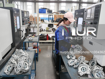 A worker is producing auto parts at a company in Lianyungang, China, on February 18, 2024. (